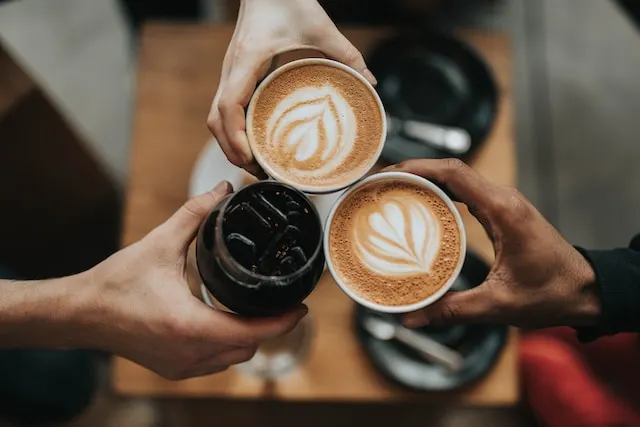 group of friends having coffee - cheers - cafe